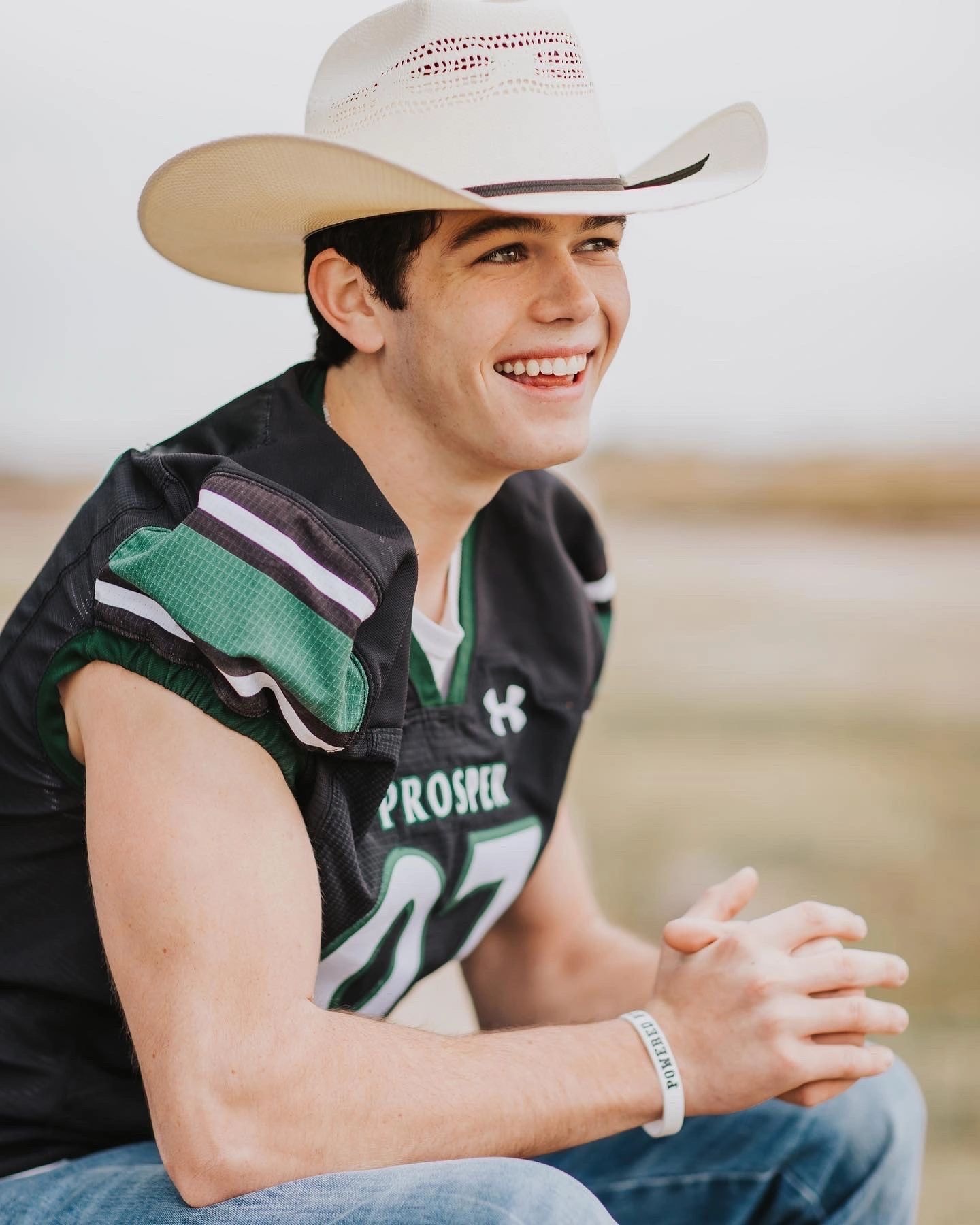 Caden Clay smiling in Prosper football jersey and cowboy hat